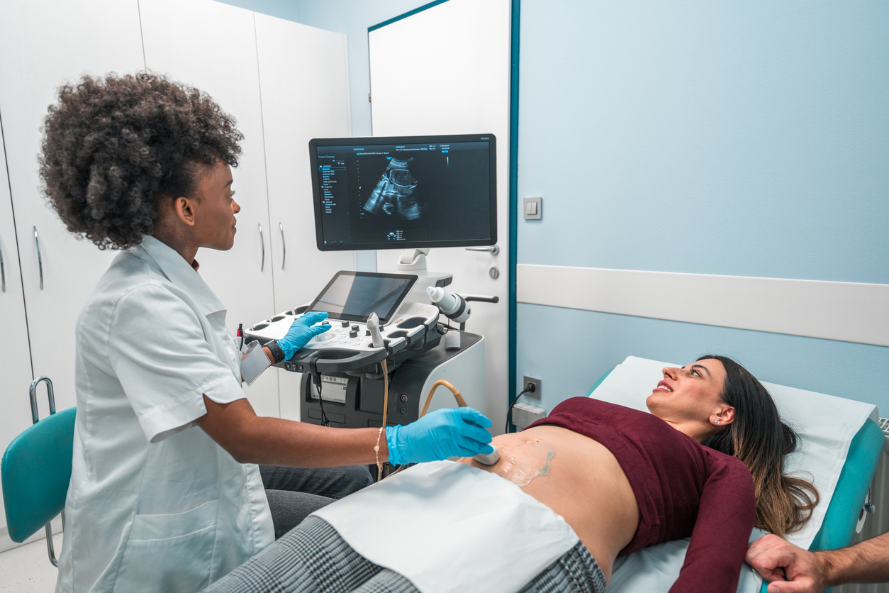 Sonographer using ultrasound to scan patient
