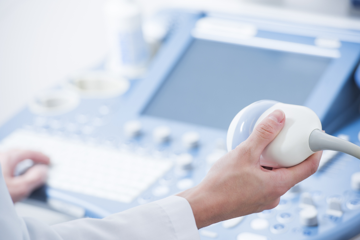 Medical professional's hands close up preparing for an ultrasound device scan